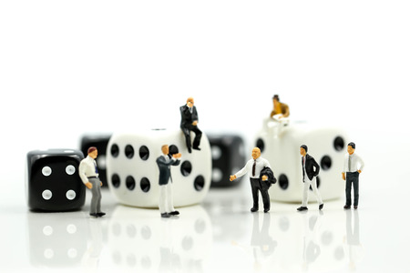 Miniature people : businessman standing with Black and white dices,Business competition Concept.の写真素材