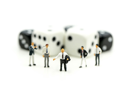Miniature people : businessman standing with Black and white dices,Business competition Concept.の写真素材
