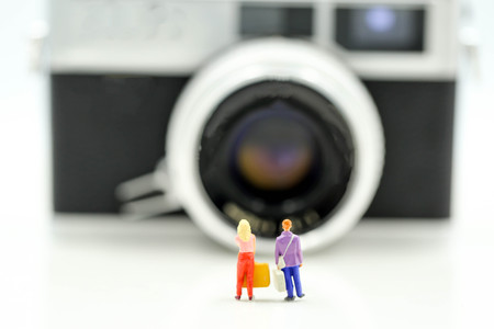 Miniature people : Couple of love  traveling backpacker  with film camera,Travel Lifestyle vacations conceptの写真素材