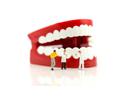Miniature people : Dentist examining a patient's teeth,healthcare medical concept.の写真素材