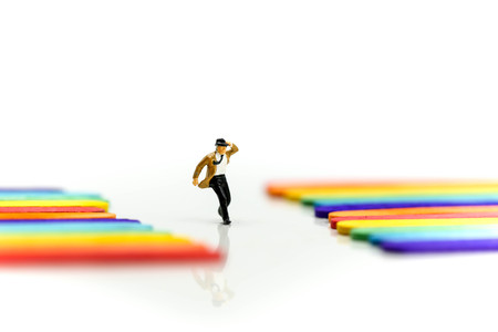Miniature people : businessman with Colorful ice cream sticks background.の写真素材
