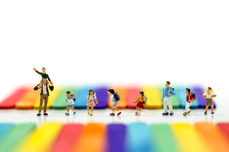 Miniature people : A group of young children getting on the schoolbus with Colorful ice cream sticks...