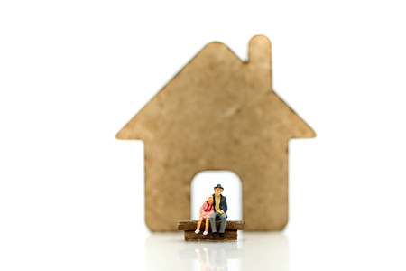 Miniature people : Couple of love sitting with house,savig property and finance concept.の写真素材