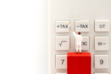 Miniature people : worker  with  Calculator button of tax, business concept.の写真素材