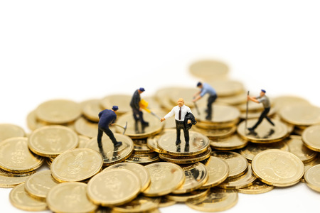 Miniature people : worker digging on coins with house,Money, Financial, Business Growth concept.の写真素材