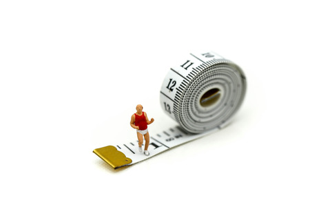 Miniature people : marathon runners with measuring tape ,jogging and running,Active and healthy lifestyle concept.の写真素材