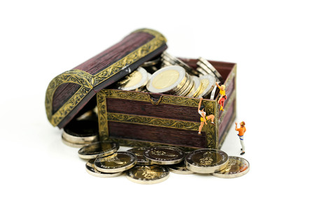 Miniature people : Climber found the treasure of gold coins,Concept of the path to purpose and success.の写真素材