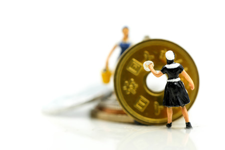 Miniature people : worker and maid cleaning golden coins.Business money concept.の写真素材