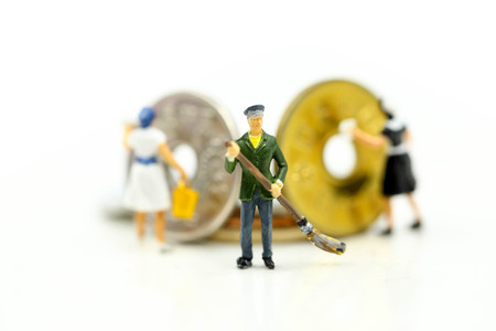 Miniature people : worker and maid cleaning golden coins.Business money concept.の写真素材