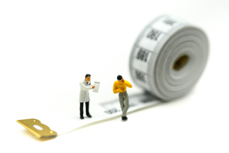 Miniature people : Doctor and patient with tape Measure,Healthcare and diet concept.