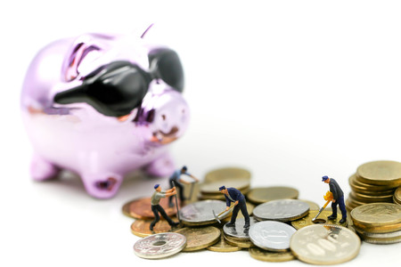Miniature people : Worker with Broken piggy bank with money,saving money concept.の写真素材