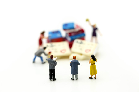 Miniature people : reading a book using as background education or business concept.