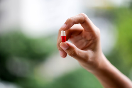 Hand is holding a lot of different pills in both his hands,healthcare concept.の写真素材