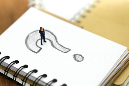 Miniature people : Businessman with THE QUESTION MARK using for concept Punctuation Dayの写真素材