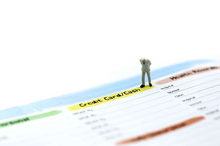 Miniature people : couple people standing with list of Credit Card,concept for Business,tax,moneyの写真素材