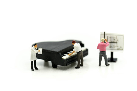 Miniature people : man play mini piano using for concept of music and International Podcast Dayの写真素材