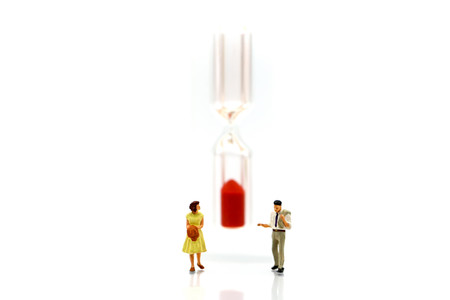 Miniature people : Businessman look a watch using for concept of time and Be Late For Something Day.