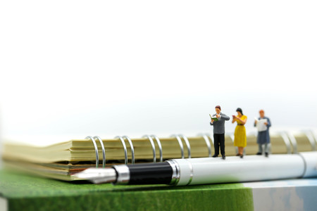 Miniature people : reading a book using concept of Read a book day.の写真素材