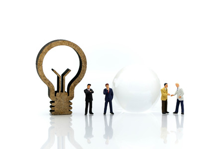 Miniature people : Businessman with jigsaw and idea lamp using for concept of swap idea day.