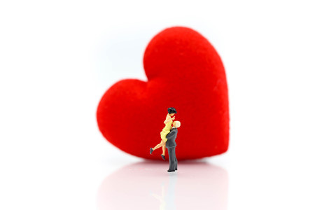 Miniature people : Couple of love with heart using for concept of First Love day or World Heart Day.の写真素材
