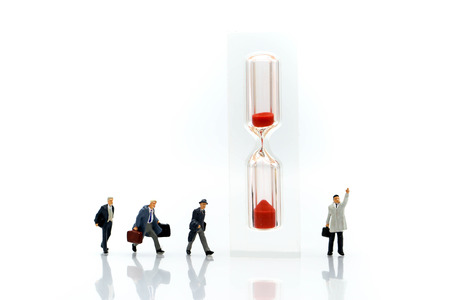 Miniature people : Businessman look a watch using for concept of time and Be Late For Something Day.