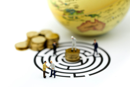 Miniature people: Businessman standing on start point of maze using as background business concept.の写真素材