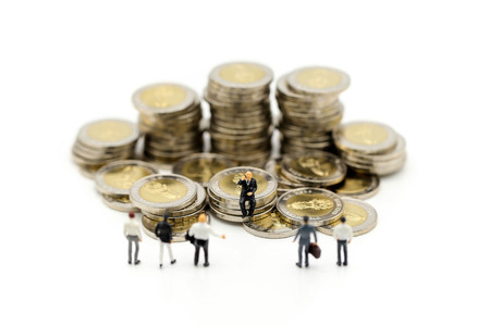Miniature people : Businessman and Boss with stack of coins using for concept of Boss Day.