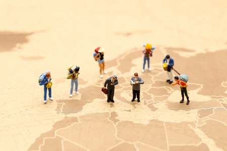 Miniature people : traveler reading a map using concept of Map Reading Week.の写真素材