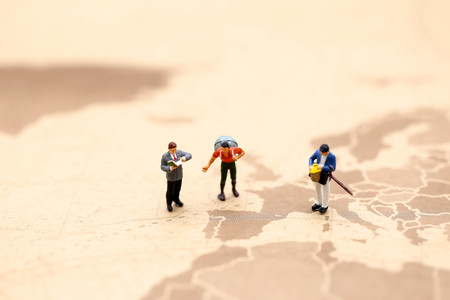 Miniature people : traveler reading a map using concept of Map Reading Week.の写真素材
