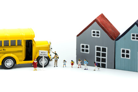Miniature people : A group of young children getting on the schoolbus,schoolbus transportation...