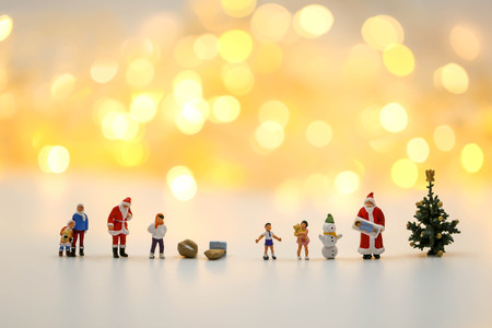 Merry christmas and happy new year Miniature People : Children with Santa Claus doll and his reindeer isolated on white background,in Christmas festival.の写真素材