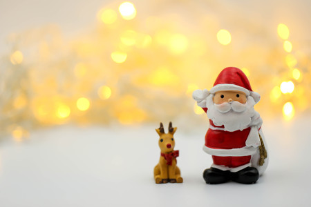 Merry christmas and happy new year Miniature People : Children with Santa Claus doll and his reindeer isolated on white background,in Christmas festival.の写真素材
