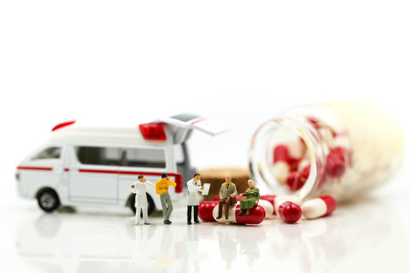 Miniature people : Doctor with patient in medical office with worker take Piill capsules,Health care concept.の写真素材