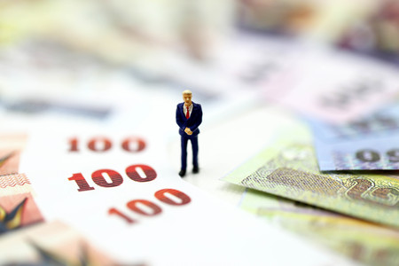 Miniature people : Businessman standing with money,financial concept and more buy power.の写真素材