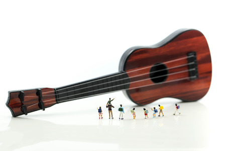 Miniature people : children and student with acoustic guitar,time of relax or music relax,stationary,education concept.の写真素材