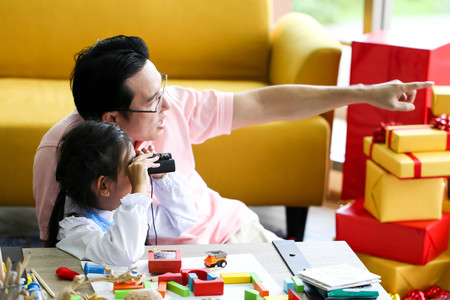 Parent and little child having fun playing educational toys,Family concept.の写真素材