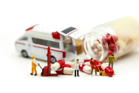 Miniature people : Doctor with patient in medical office with worker take Piill capsules,Health care concept.の写真素材