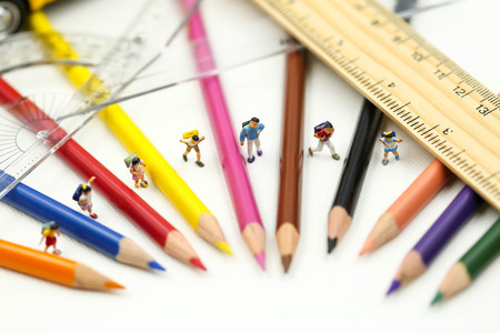 Miniature people : teacher and student with colorful drawing tools and stationary of school bus,education concept.の写真素材