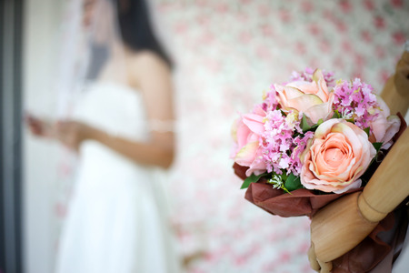 Bride in dress holding wedding bouquet of flowers and greenery,Happy wedding concept.の写真素材