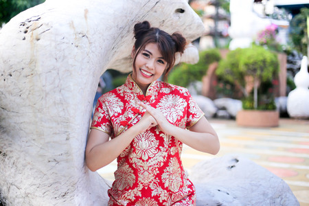 Portrait of a beautiful Asian Woman hold with luck money and red pocket,chinese new year concept.