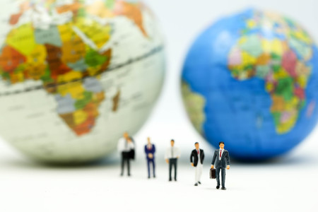 Miniature people : Businessman team with miniworld ,International business concept.