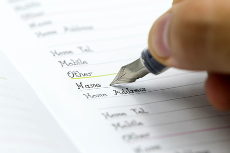 Writing the name on a paper with a pen using for concept of Namesake day.