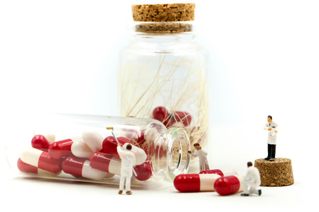 Miniature people : Doctor and worker with Drug pill vitamin c of bottle using for concept of Vitamin...