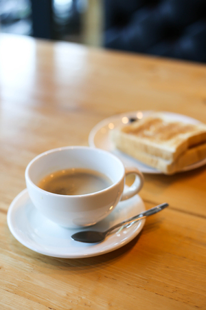 Hot coffee and American breakfast with sunny side up eggs, bacon, toastの写真素材