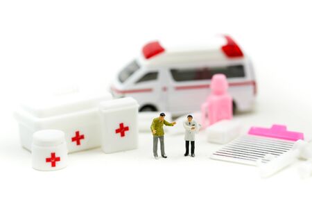 Miniature people : Doctor and Paramedic attending to patient in ambulance,Medicine ambulance conceptの写真素材