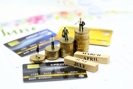 Miniature people : businessman with credit card and stack coins, commitment, agreement, investment, business and partnership conceptの写真素材