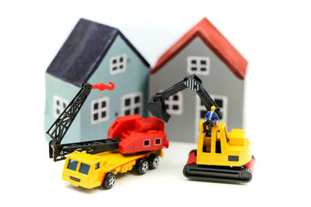 Miniature people : worker team for building home ,Image use for construction, business concept,house repair or home renovatingの写真素材