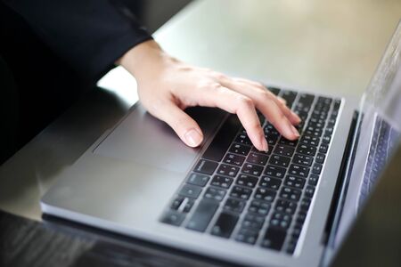 Close up of business women working with typing on laptop empty at workplace.Selective focus,business...