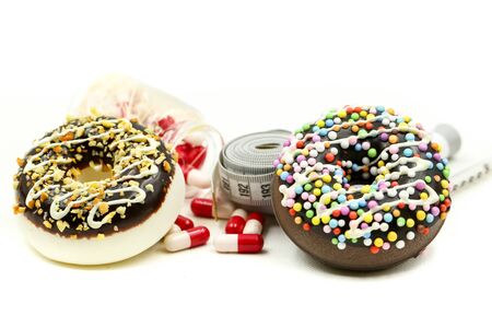 Donut tying by measuring tape and drug Capsule of medicine,dietary for slim shape concept,Take medicine, drug for diet in concept.の写真素材