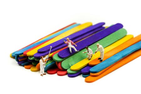 Miniature people : worker painting on Colorful ice cream sticksの写真素材